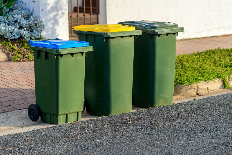 kerbside waste bins ready for collection by local council in australian suburb